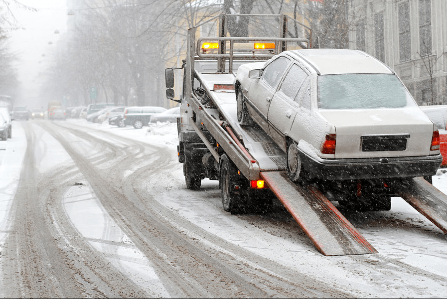 a car being towed because of the snow